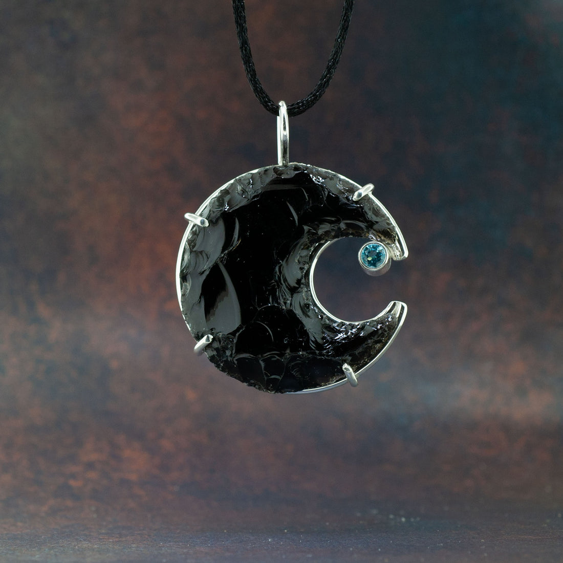Obsidian crescent moon with aquamarine stone