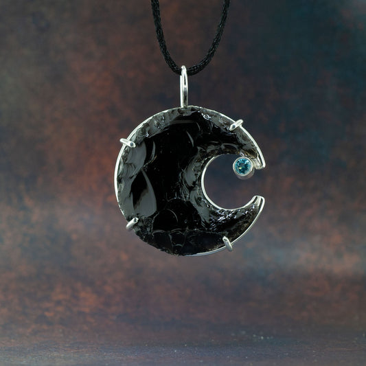 Obsidian crescent moon with aquamarine stone