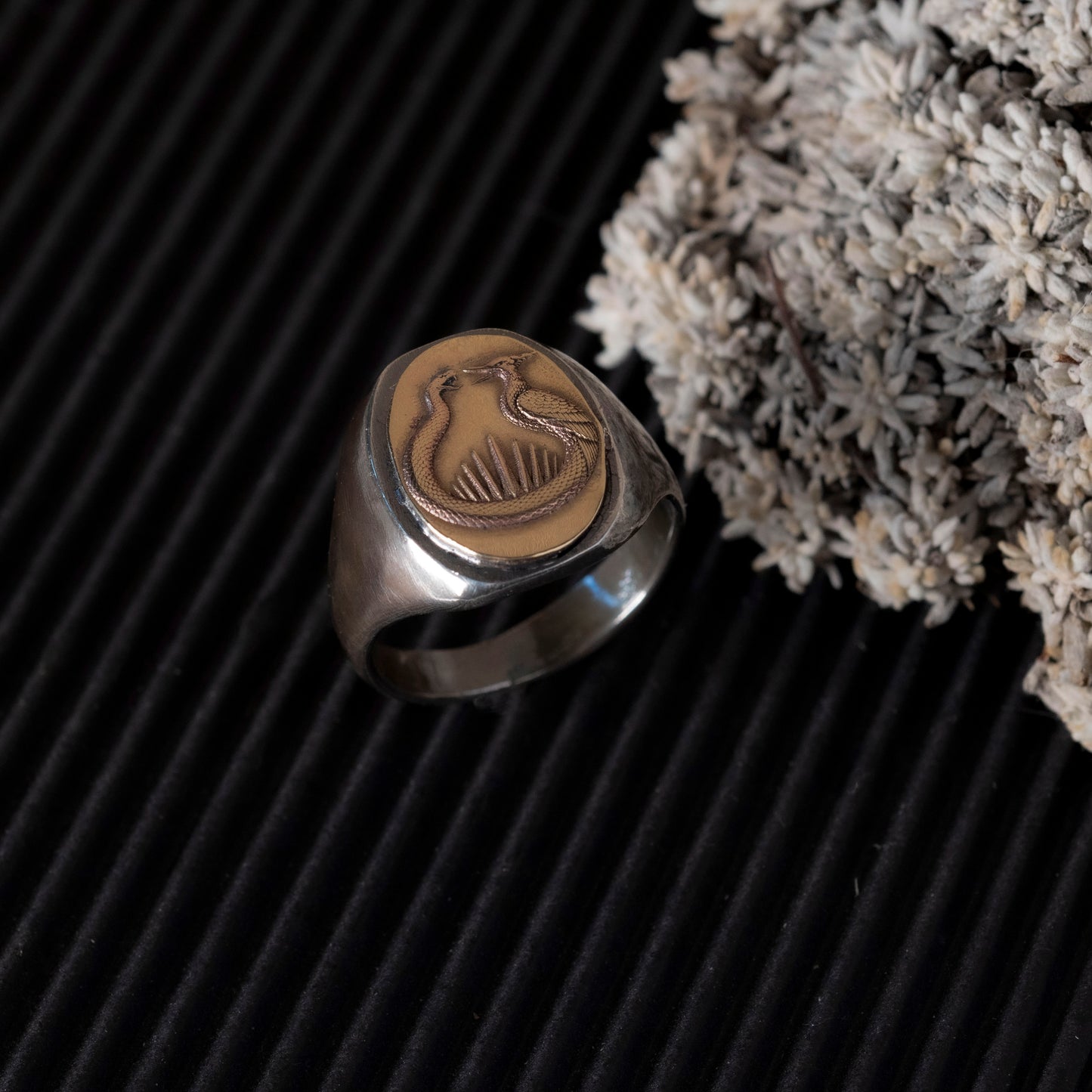 Solid silver sandcasted signet ring with a brass snake and mockingjay flint striker motif