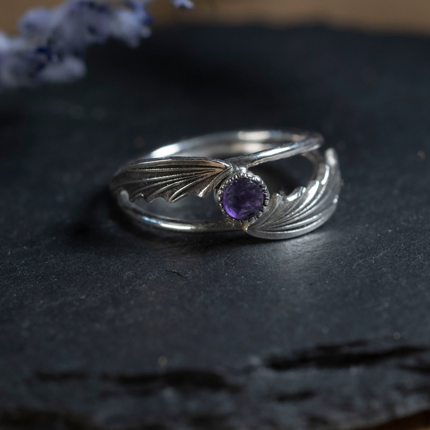Close-up of the delicate silver wings and the 4mm amethyst stone on the ring