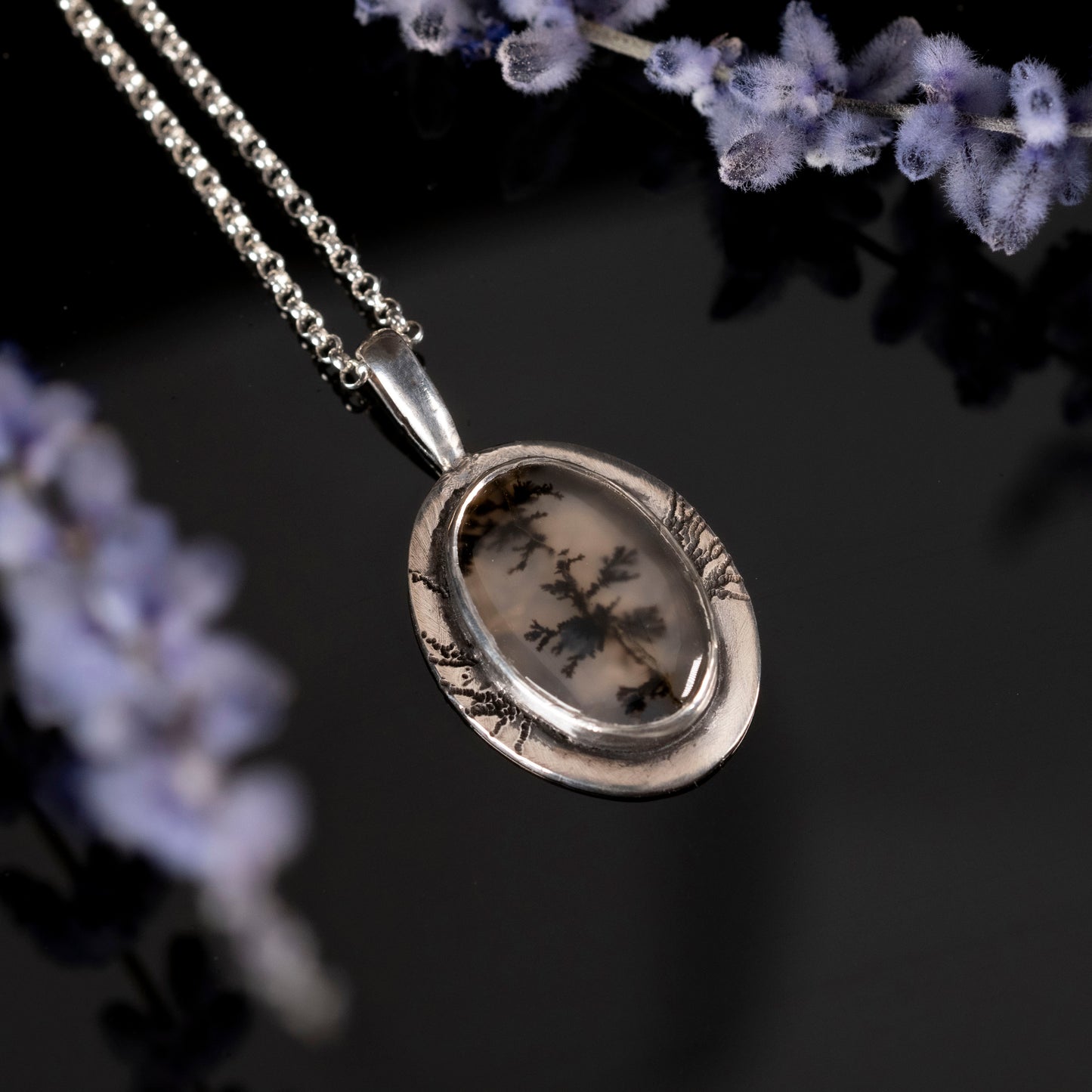 Silver pendant necklace with floral dendritic agate background