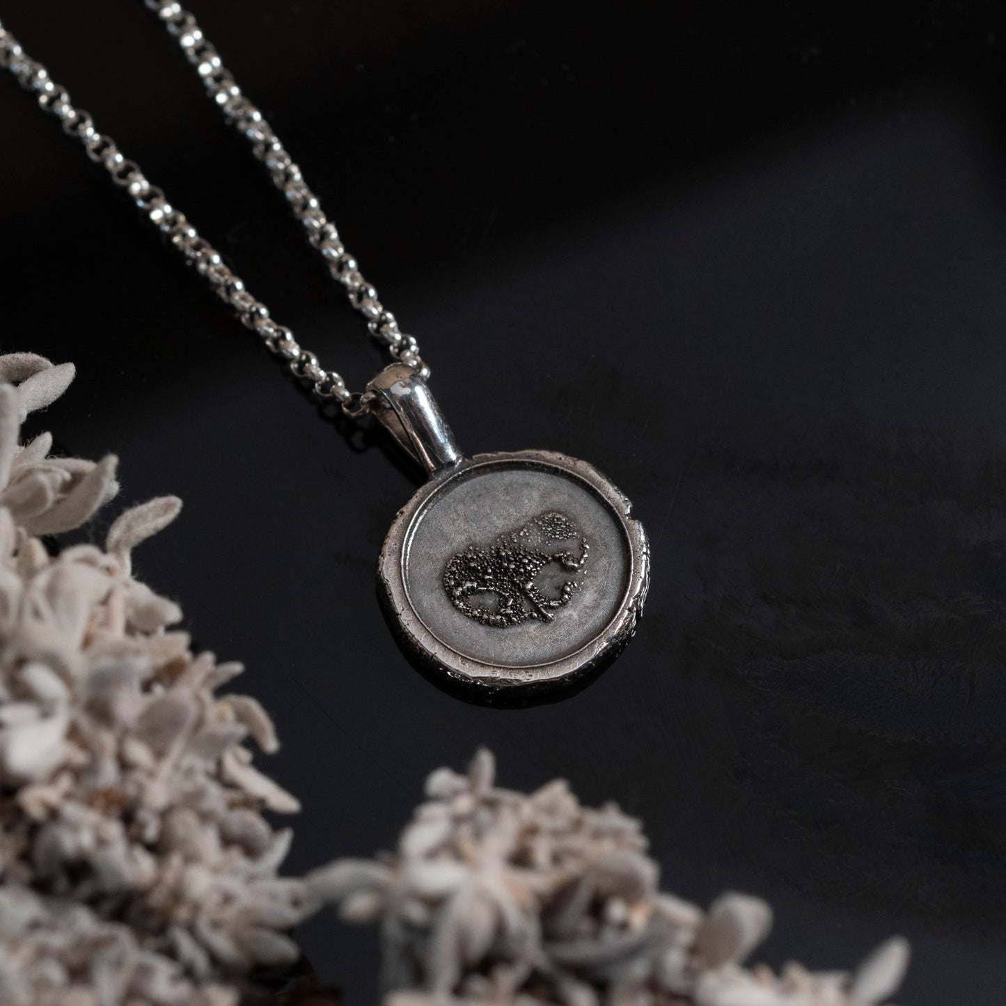 Silver necklace with a pendant with nose imprint