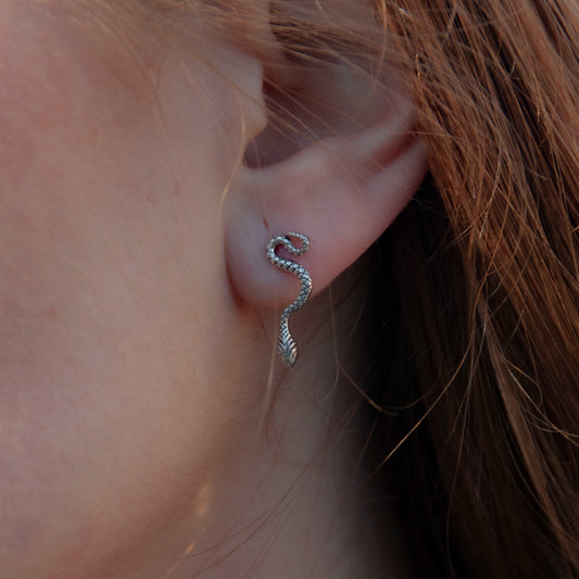 Model wearing the small silver snake post earrings