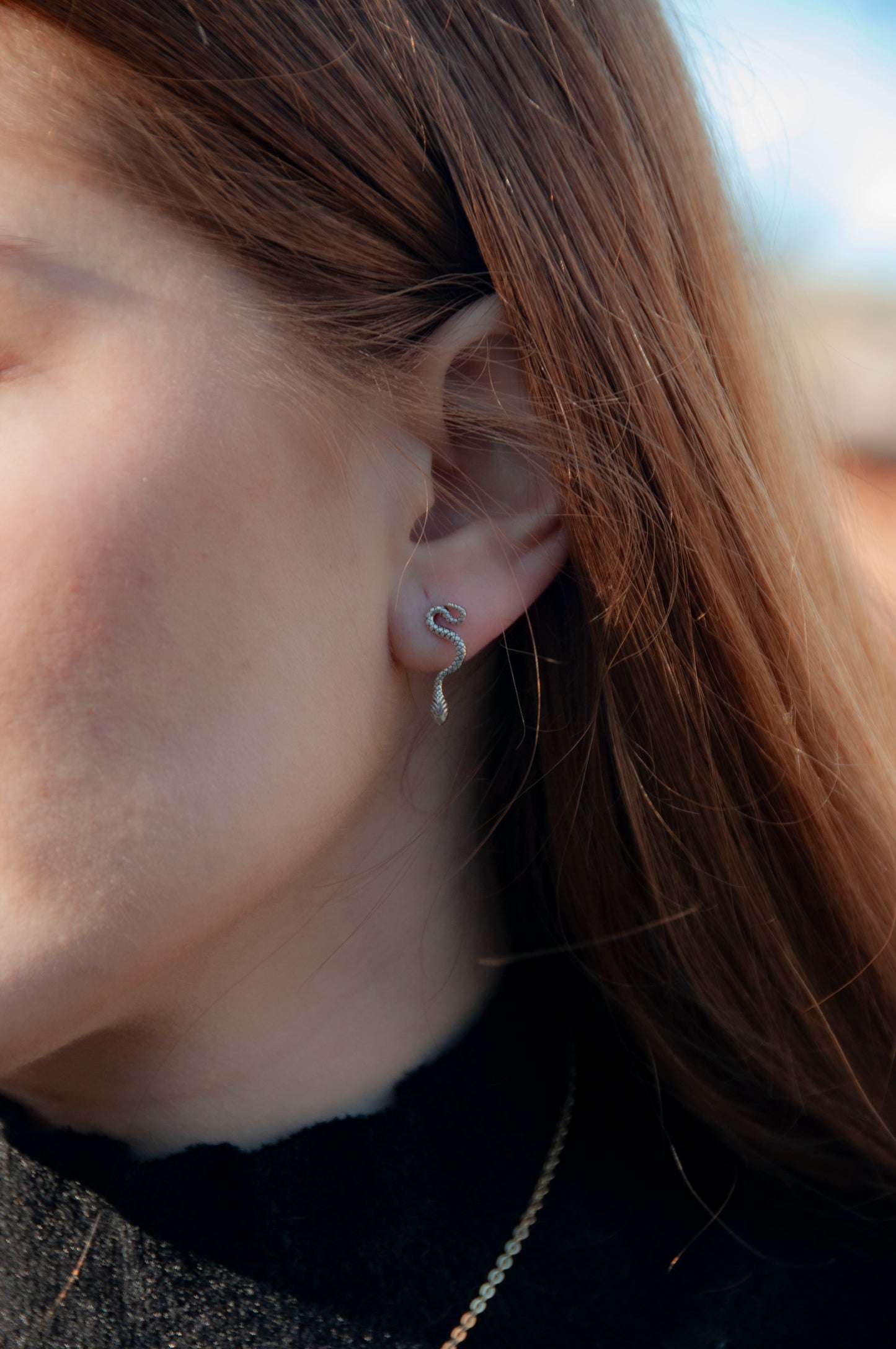 Model wearing the small silver snake post earrings