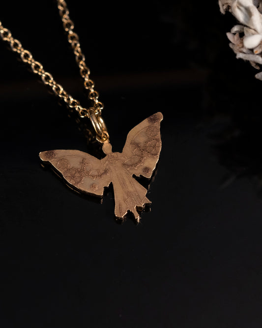 Close-up of the laser engraved details on the brass Clockwork Angel pendant