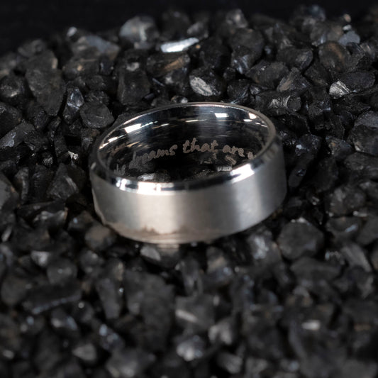 Image of the inside of the stainless steel ring, clearly showing the 'To the stars who listen and the dreams that are answered' quote