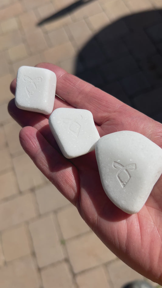 Close-up of the etched Angelic Power Rune on the sparkling gray marble stone. The smooth Santorini marble worry stone, perfect for a Shadowhunters collection.