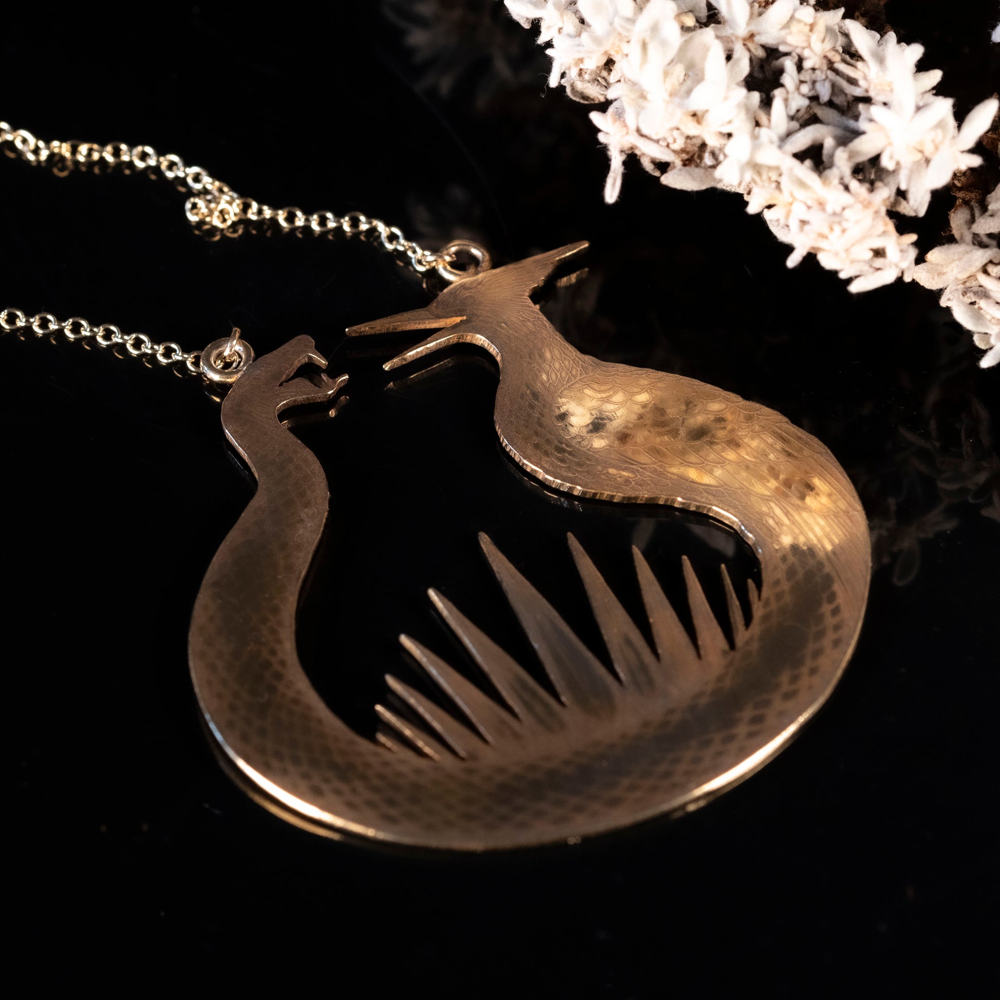 Detailed view of the brass flint striker pendant