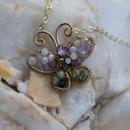 Wire wrapped butterfly necklace in brass and watermelon tourmalines