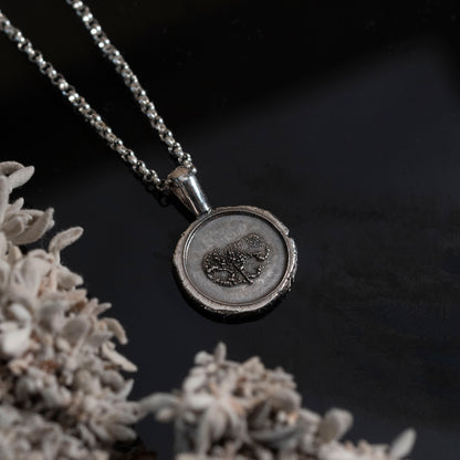 Silver necklace with a pendant with nose imprint