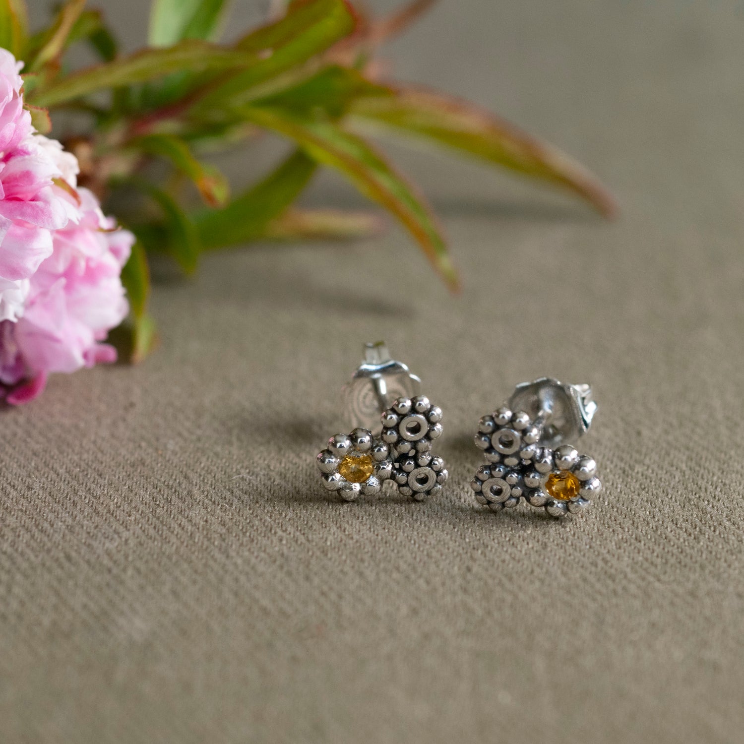 Triple daisy cluster stud earrings in sterling silver with a natural citrine center, hand-fabricated botanical jewelry by Hebel Design