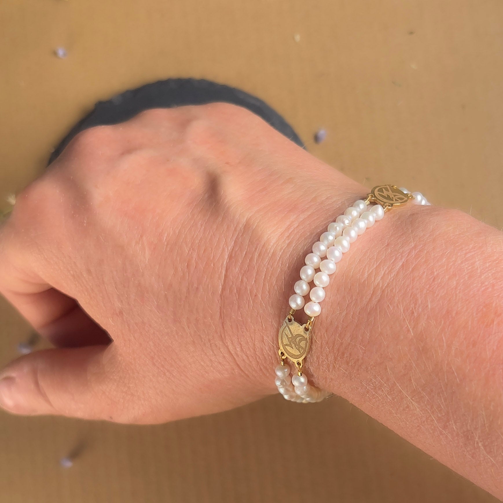 The Infernal Devices inspired pearl bracelet on a model's wrist