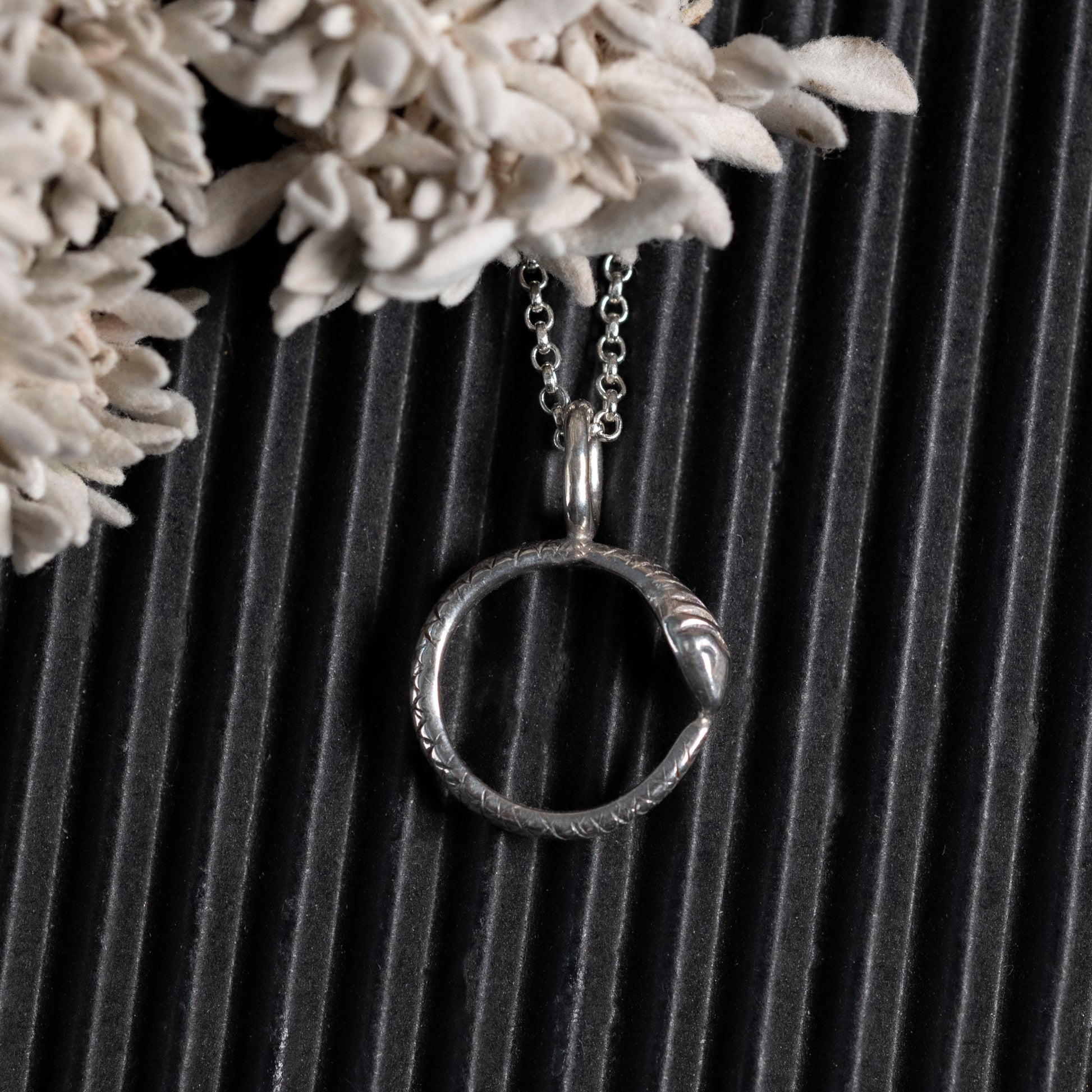 Tiny ouroboros necklace