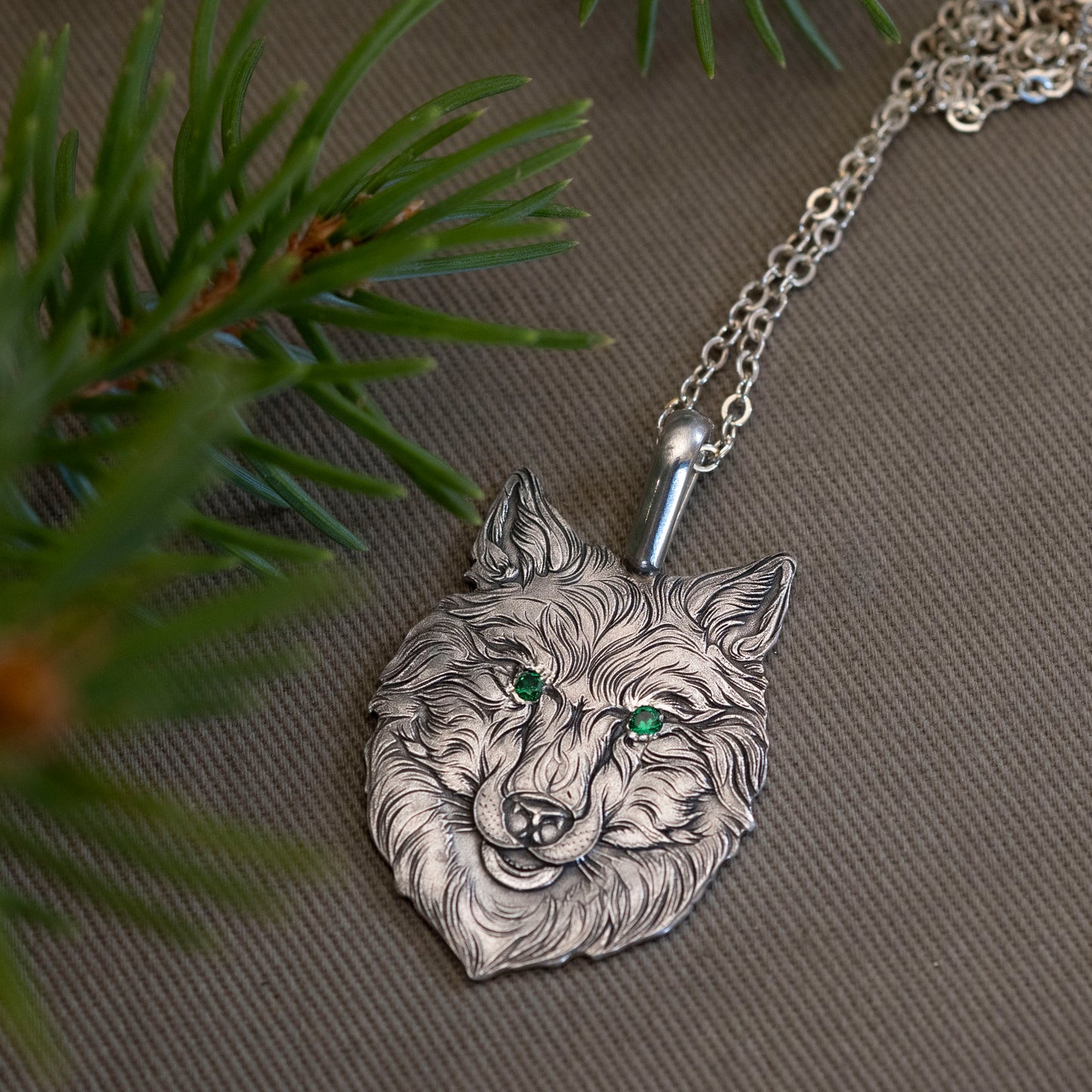 A wolf’s head was set in the steel, its eyes bejeweled in green