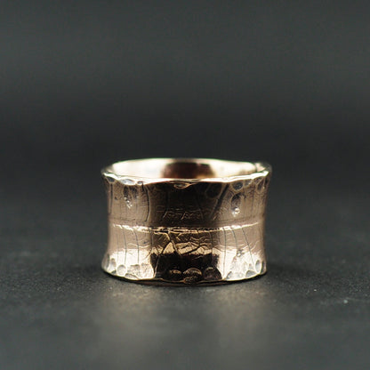 Close-up of the engraved leaf skeleton texture on the brass ring